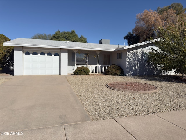 single story home featuring an attached garage, covered porch, and concrete driveway