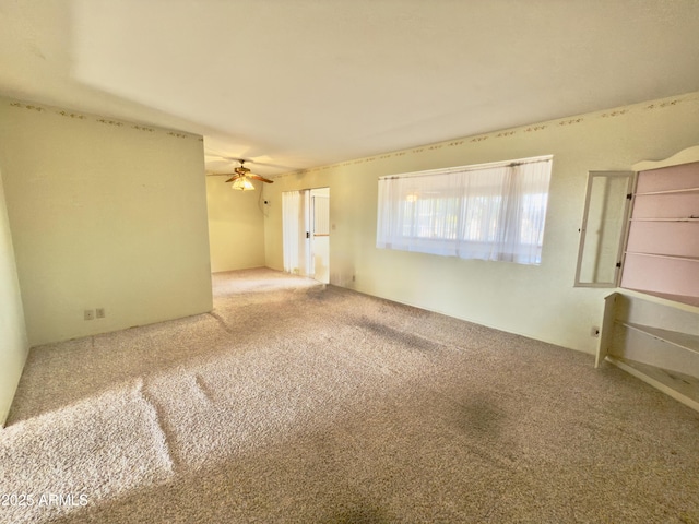 spare room with carpet and ceiling fan