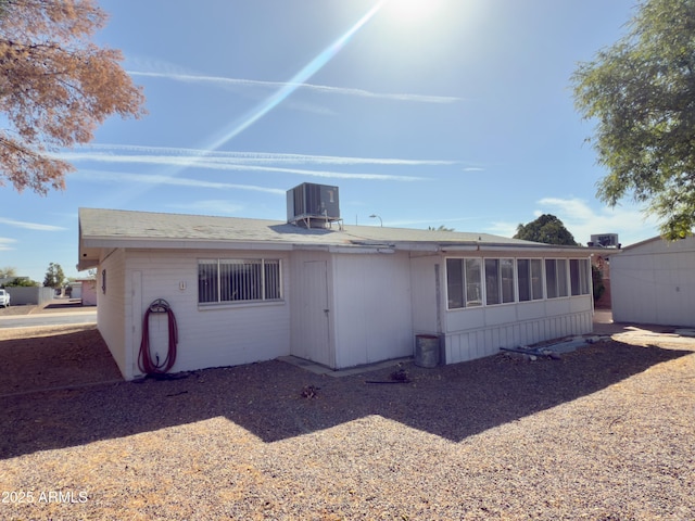 back of house with central AC unit