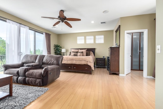 bedroom with light hardwood / wood-style floors and ceiling fan