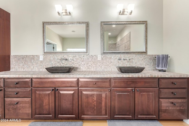 bathroom with decorative backsplash and vanity