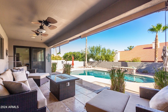 view of patio with a fenced in pool, an outdoor living space with a fire pit, and ceiling fan