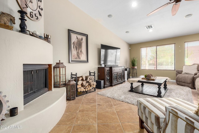 living room featuring ceiling fan and vaulted ceiling