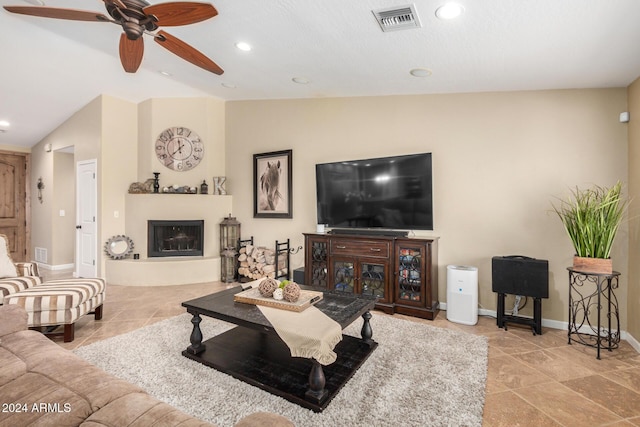 living room featuring ceiling fan and lofted ceiling