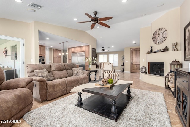 living room featuring ceiling fan and lofted ceiling