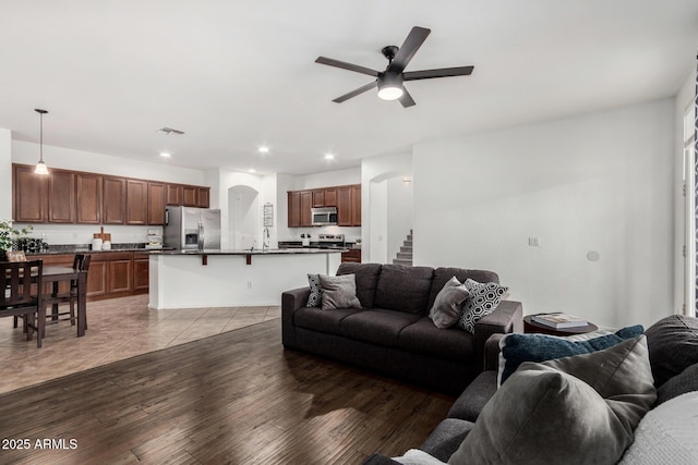 2986 E Country Shadows St, Gilbert, AZ 85298 - living area with a ceiling fan, recessed lighting, arched walkways, stairs, and light wood-style floors