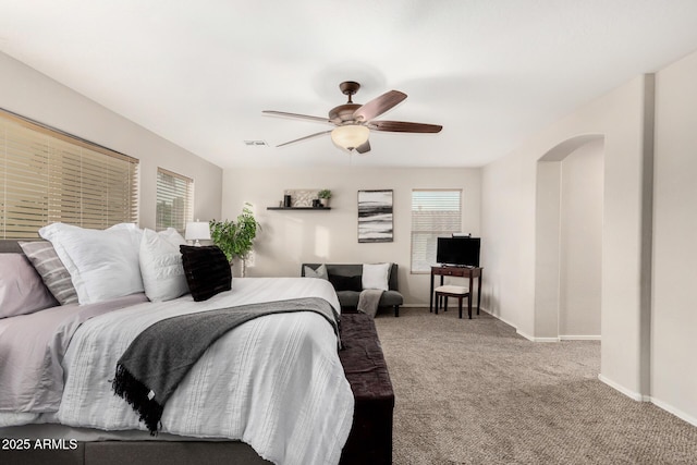 2986 E Country Shadows St, Gilbert, AZ 85298 - carpeted bedroom featuring baseboards, a ceiling fan, and arched walkways