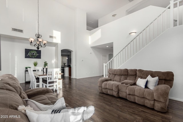 2986 E Country Shadows St, Gilbert, AZ 85298 - living area with stairs, arched walkways, a chandelier, dark wood-style floors, and baseboards