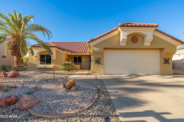 mediterranean / spanish home featuring a garage