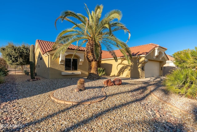 mediterranean / spanish-style house featuring a garage