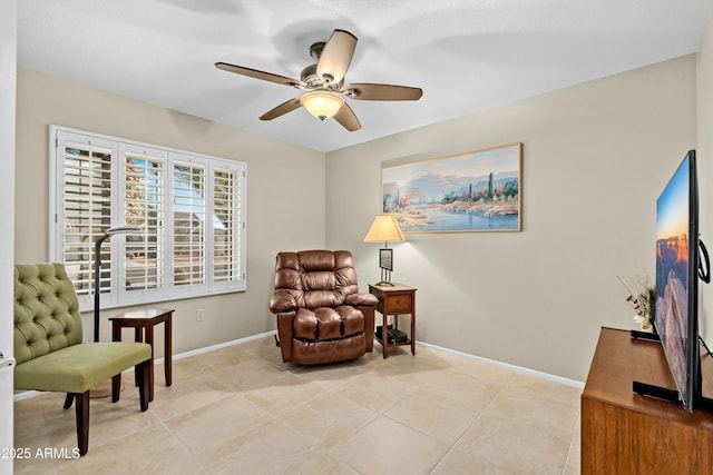 sitting room featuring ceiling fan and light tile patterned floors