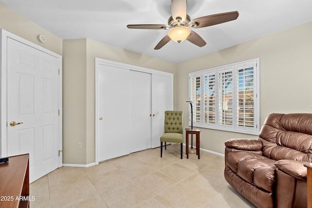 sitting room with ceiling fan and light tile patterned flooring