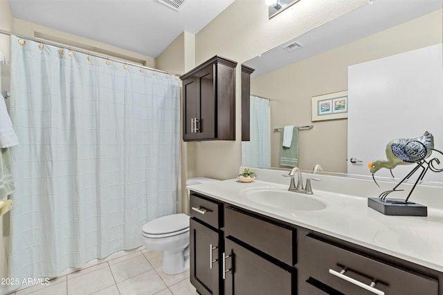 bathroom with tile patterned floors, vanity, and toilet