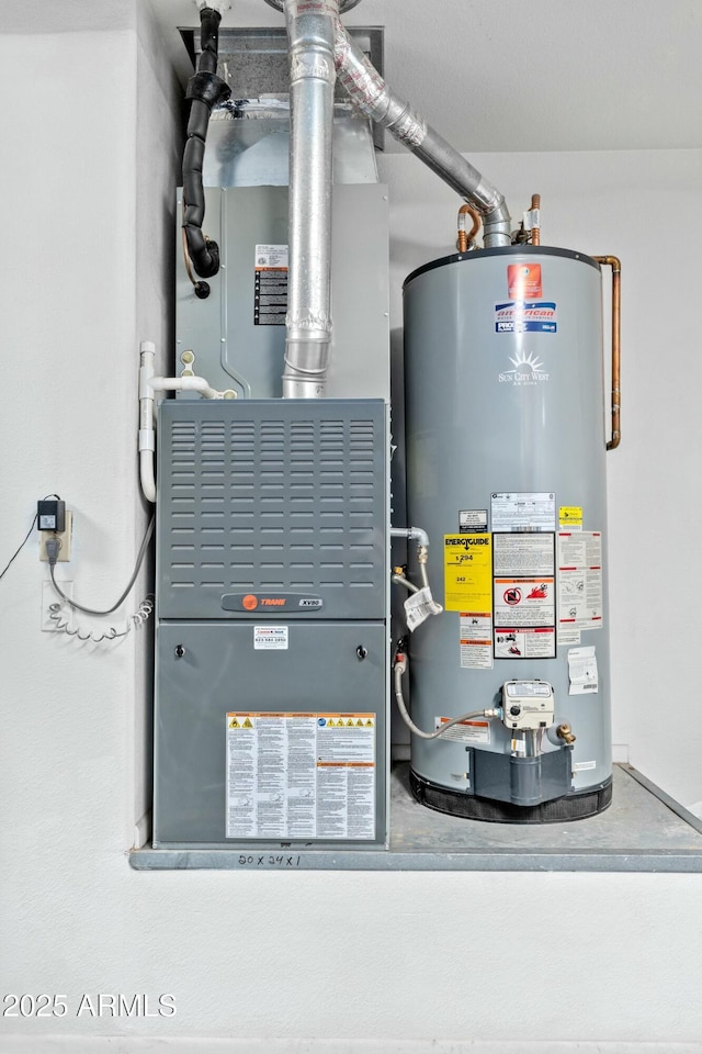 utility room featuring heating unit and gas water heater