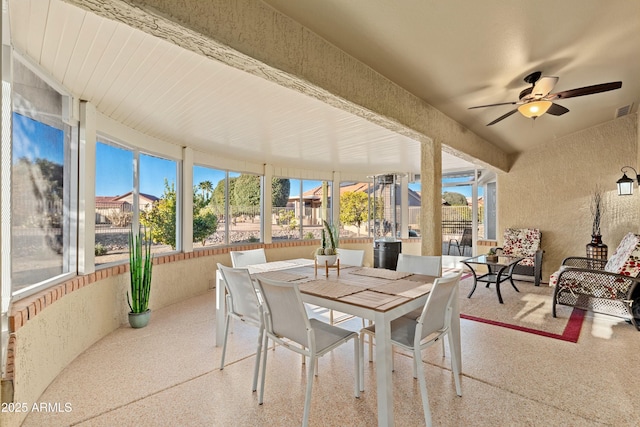 sunroom / solarium featuring ceiling fan