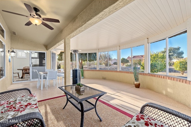 sunroom / solarium with ceiling fan and vaulted ceiling