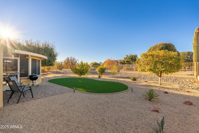 view of yard with a sunroom and a patio