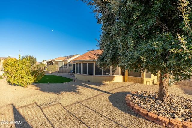 rear view of property featuring a sunroom