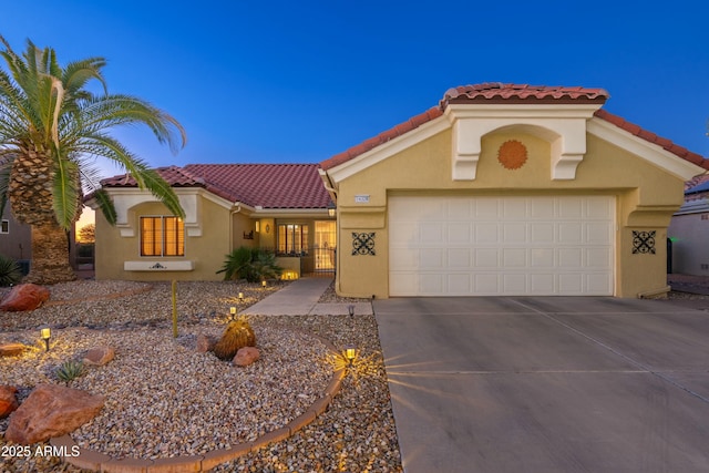 mediterranean / spanish-style home with a garage