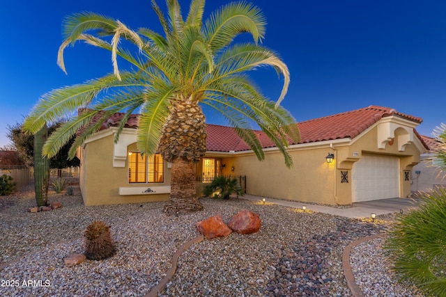 mediterranean / spanish-style home with a garage