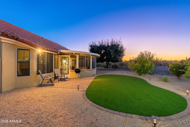 yard at dusk with a patio