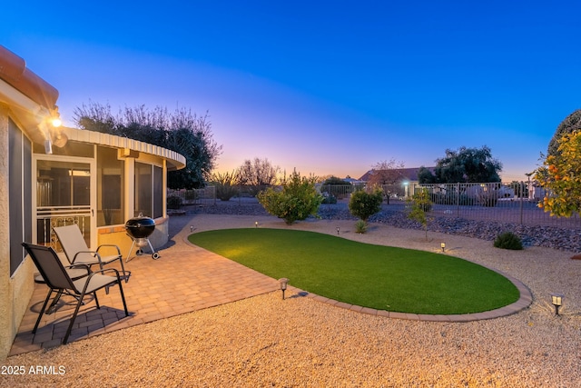 yard at dusk with a patio