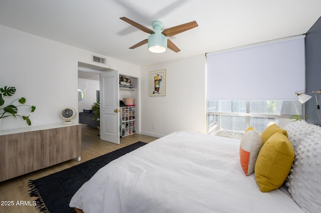 1225 E Medlock Dr Unit 206, Phoenix, AZ 85014 - bedroom with wood finished floors, ceiling fan, and baseboards