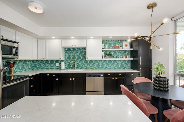 1225 E Medlock Dr Unit 206, Phoenix, AZ 85014 - kitchen featuring appliances with stainless steel finishes, a sink, dark cabinets, and white cabinetry