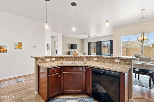 kitchen featuring a sink, pendant lighting, dishwasher, open floor plan, and ceiling fan