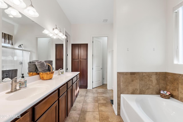 bathroom featuring tile patterned flooring, a sink, a shower stall, and a bath