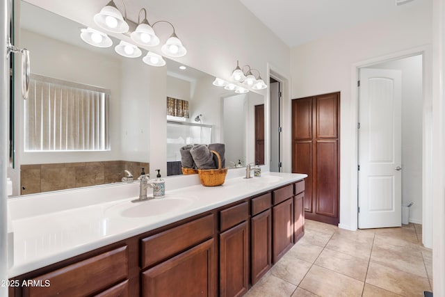 bathroom featuring tile patterned flooring, a sink, and double vanity
