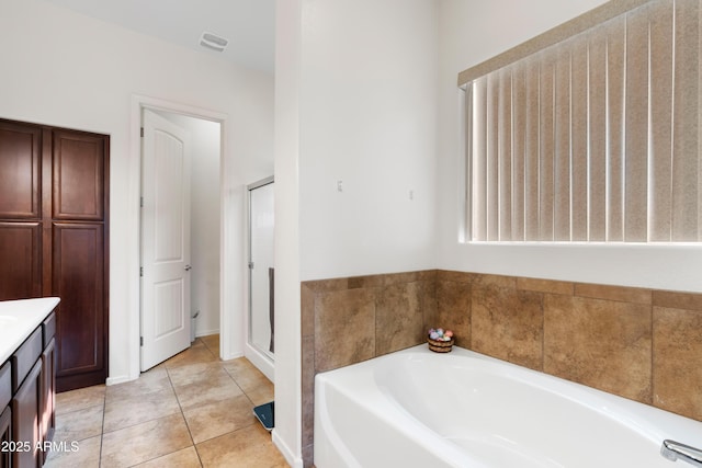 bathroom featuring vanity, a shower stall, tile patterned floors, visible vents, and a bath