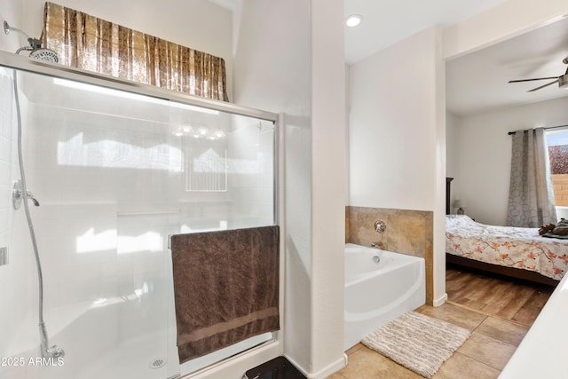 ensuite bathroom featuring ensuite bathroom, a shower stall, ceiling fan, a garden tub, and tile patterned flooring