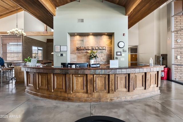 reception featuring visible vents and an inviting chandelier