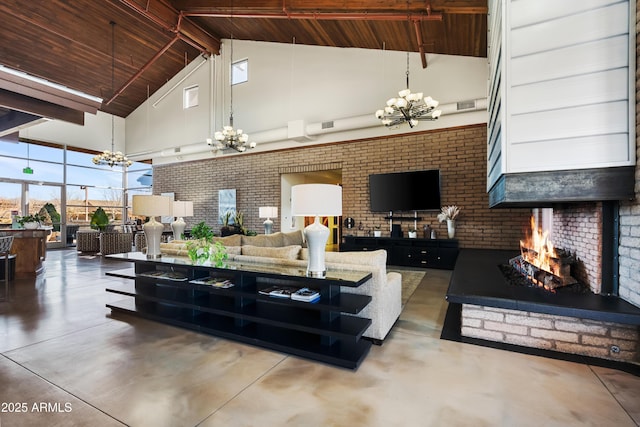 living area featuring finished concrete flooring, high vaulted ceiling, visible vents, a chandelier, and brick wall