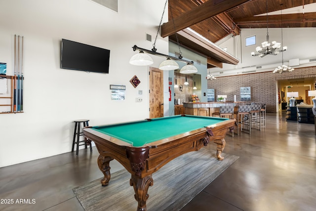 game room featuring high vaulted ceiling, a chandelier, beam ceiling, finished concrete floors, and pool table