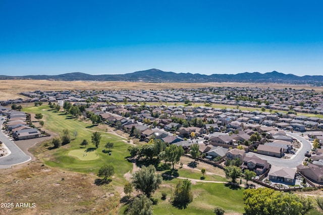 birds eye view of property with a mountain view, view of golf course, and a residential view