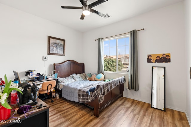 bedroom with light wood-style flooring, ceiling fan, and visible vents