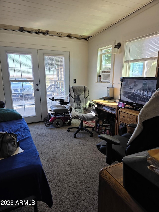 bedroom with multiple windows, access to outside, carpet flooring, and cooling unit