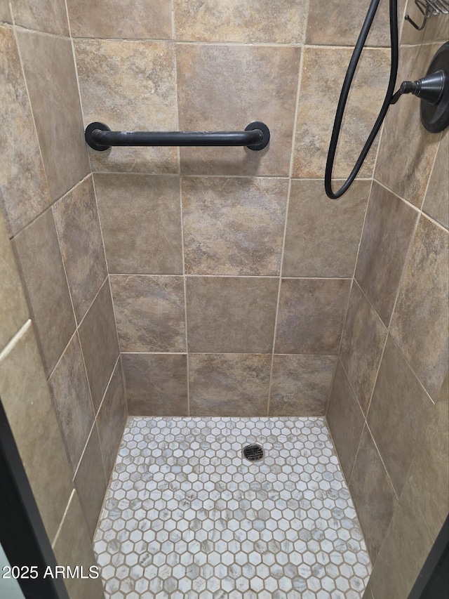 bathroom with tiled shower