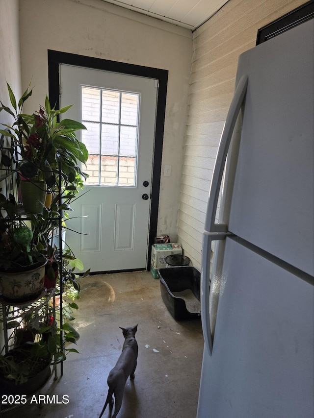 doorway to outside featuring concrete flooring