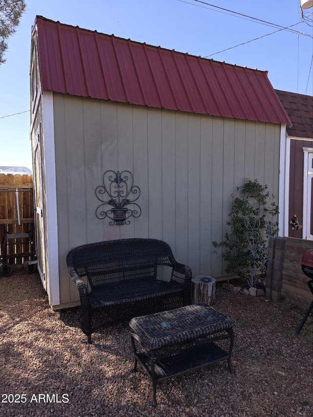 view of shed featuring fence