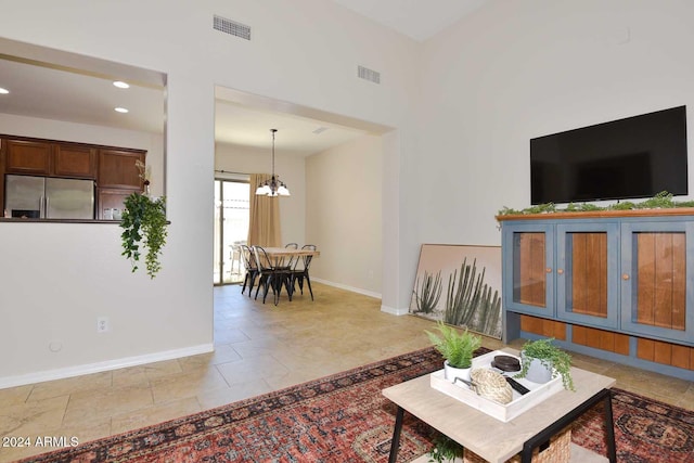 living room with light tile patterned floors and a notable chandelier