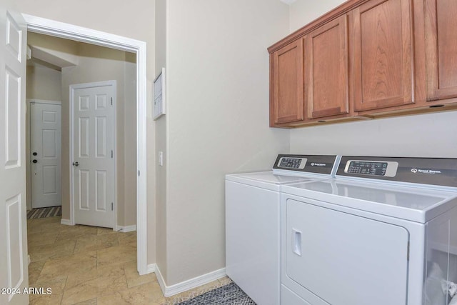 laundry room featuring cabinets and separate washer and dryer