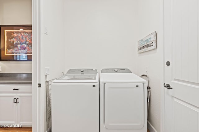 clothes washing area featuring washer and clothes dryer