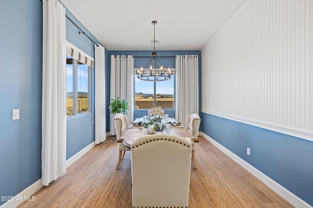 dining area featuring a chandelier and hardwood / wood-style floors