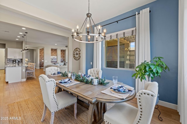 dining space featuring a chandelier and light wood-type flooring