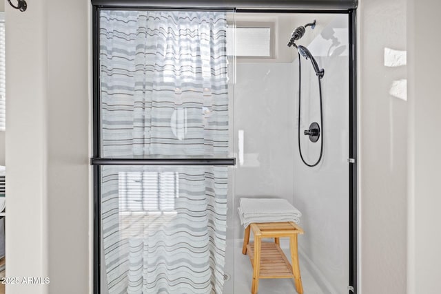 bathroom with a shower with shower door