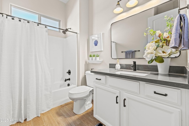 full bathroom with vanity, toilet, hardwood / wood-style floors, and shower / bath combo with shower curtain