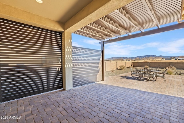 view of patio / terrace featuring a mountain view and a pergola